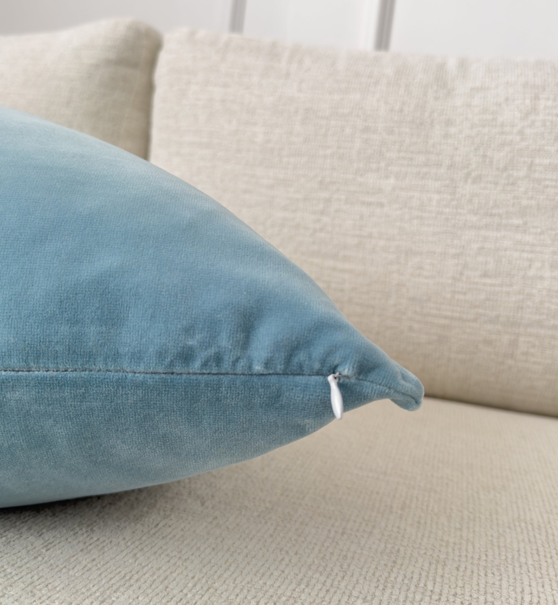 a close up of a blue pillow on a couch