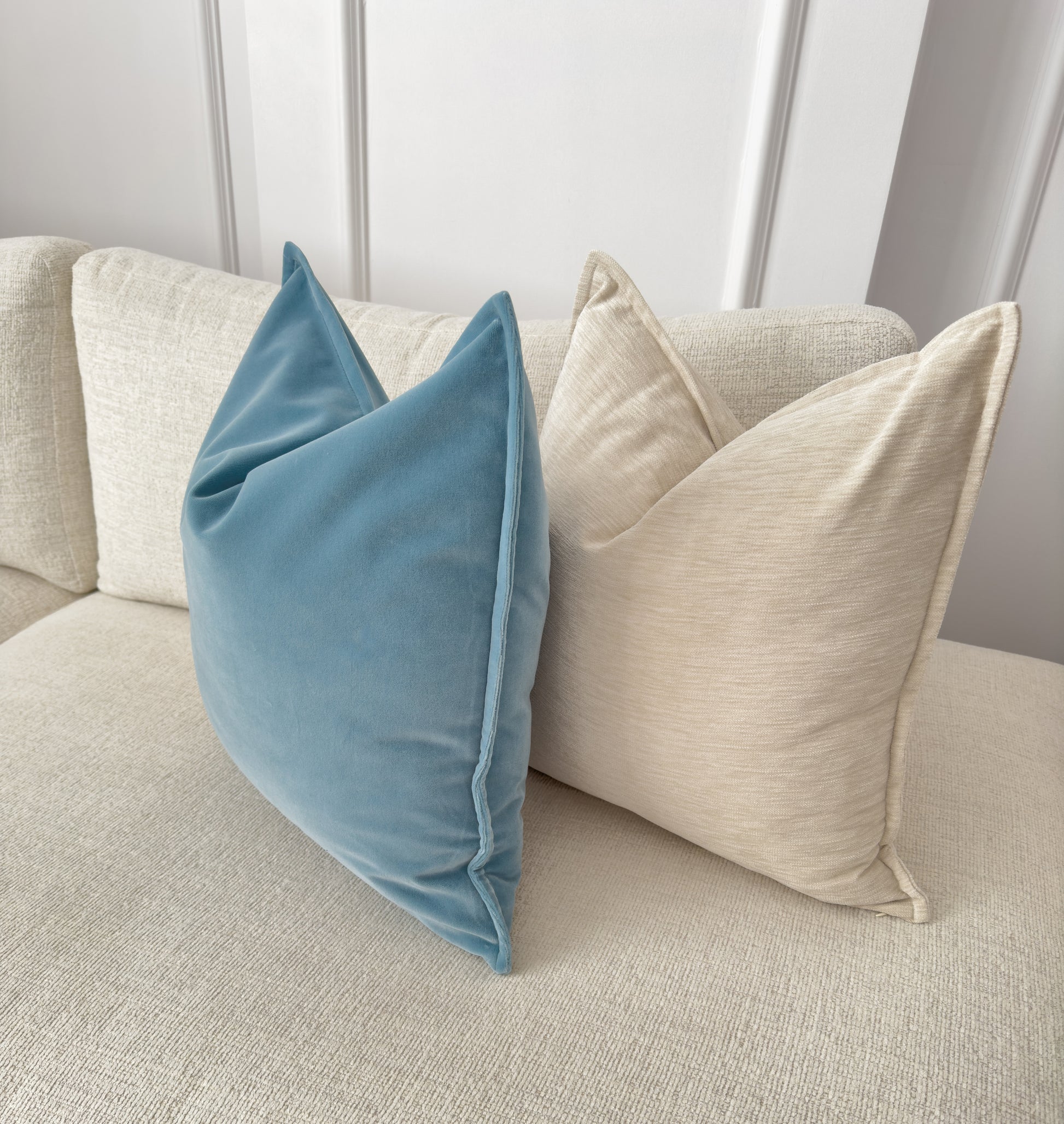 a close up of two pillows on a couch