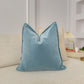 a blue pillow sitting on top of a white couch