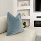 a white couch with a blue pillow on it