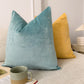 a close up of two pillows on a bed