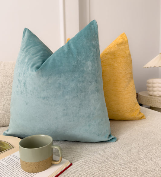 a close up of two pillows on a bed