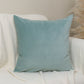 Light blue pillow on a white armchair with a neutral background