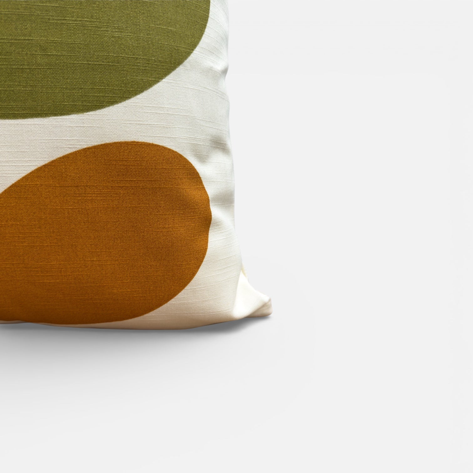 Decorative pillow with green and brown abstract design on a white background