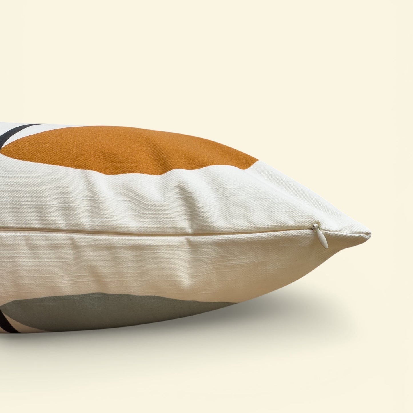 Decorative pillow with a two-tone design on a beige background