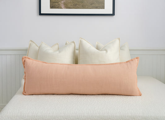 Dusty pink linen extra long lumbar cushion cover on white bed