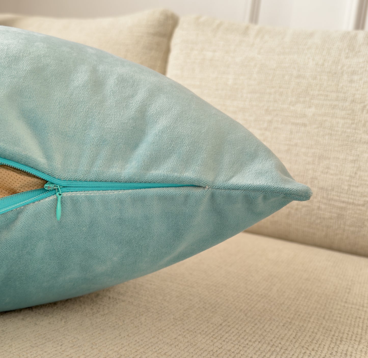 a pillow with a zipper on it sitting on a couch
