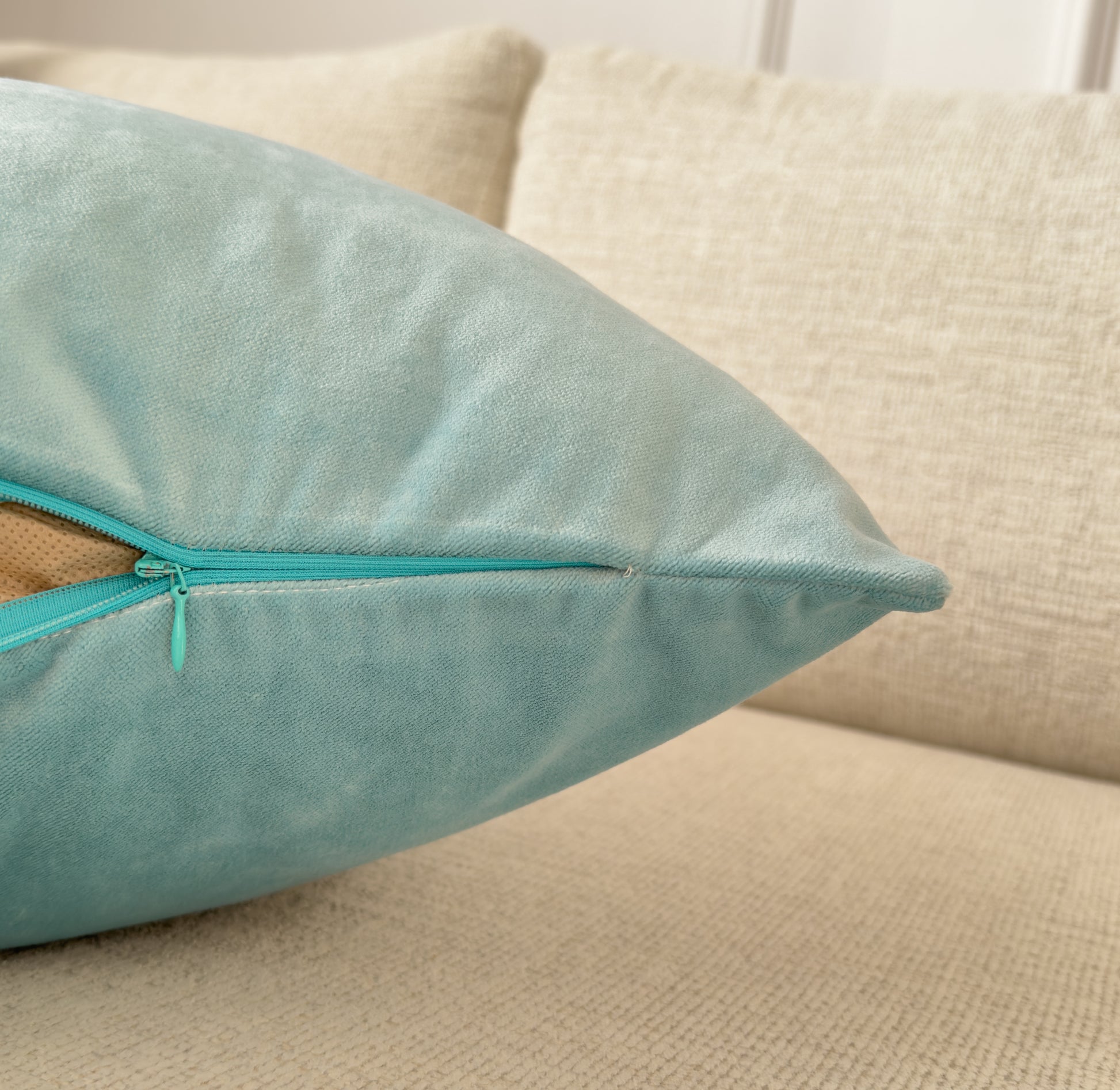 a pillow with a zipper on it sitting on a couch